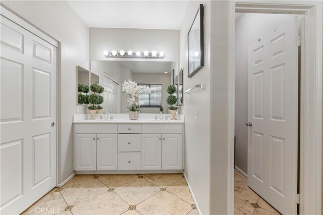 bathroom featuring tile patterned flooring and vanity