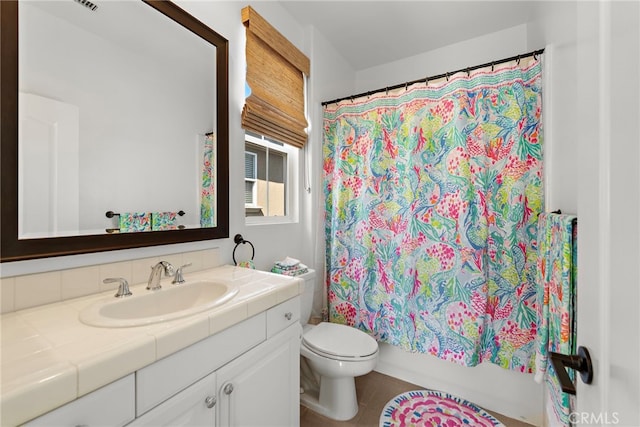 full bathroom with shower / bath combination with curtain, vanity, and toilet