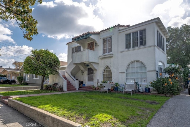 mediterranean / spanish-style home featuring a front lawn