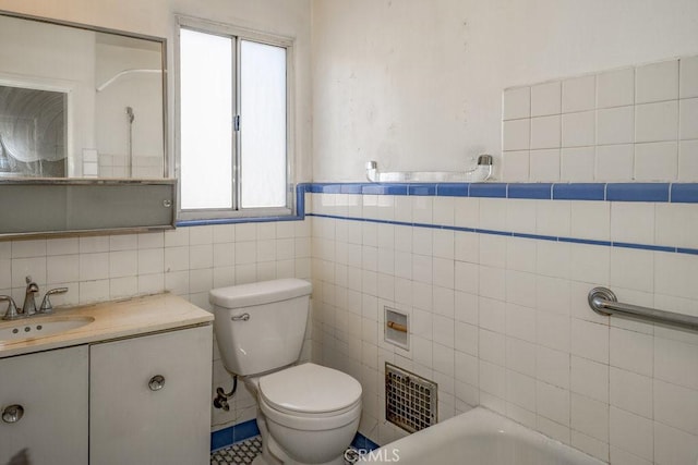 1314 E Harvard St, Glendale, CA 91205 - bathroom with tile walls, toilet, vanity, a bathtub, and wainscoting