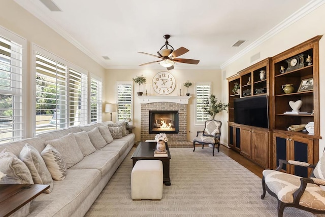 living room featuring a fireplace, visible vents, crown molding, and wood finished floors