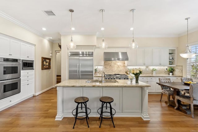 kitchen featuring built in appliances, under cabinet range hood, a sink, visible vents, and open shelves