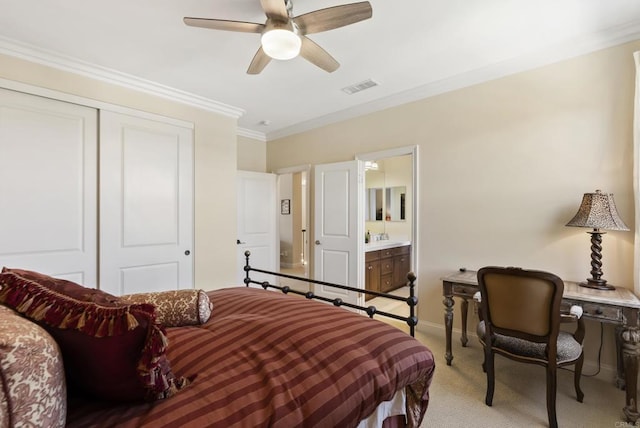 bedroom featuring a closet, visible vents, light colored carpet, crown molding, and a sink