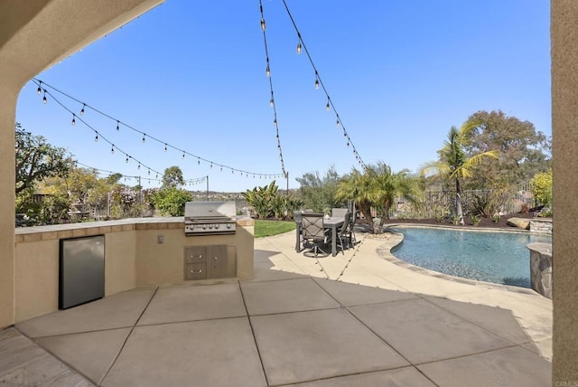 view of patio / terrace with exterior kitchen, area for grilling, outdoor dining space, and an outdoor pool