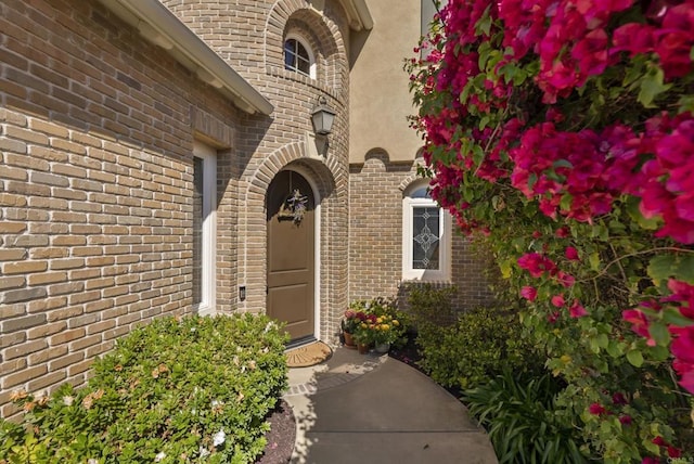 property entrance featuring brick siding