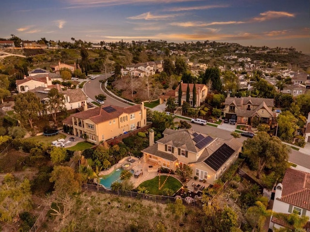 aerial view at dusk featuring a residential view