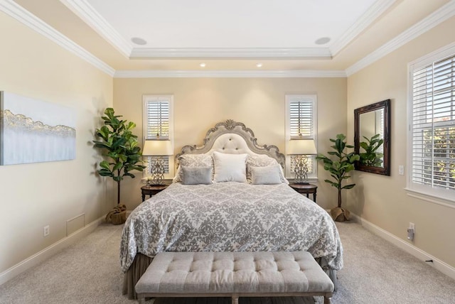 bedroom featuring a tray ceiling, carpet flooring, and baseboards