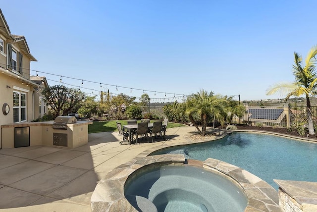 view of pool with a grill, outdoor dining area, exterior kitchen, a patio area, and a pool with connected hot tub