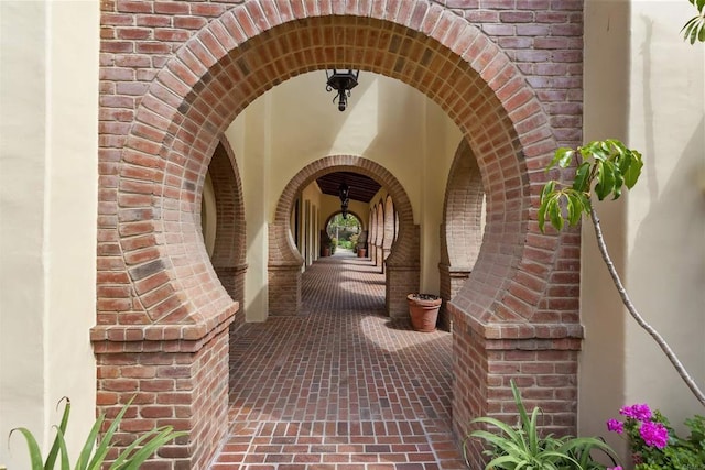 doorway to property with brick siding