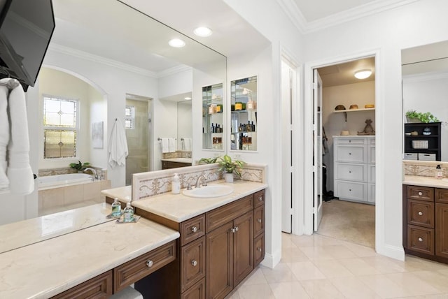 full bathroom with crown molding, two vanities, a stall shower, a sink, and a bath