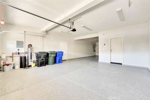 garage featuring electric panel and a garage door opener