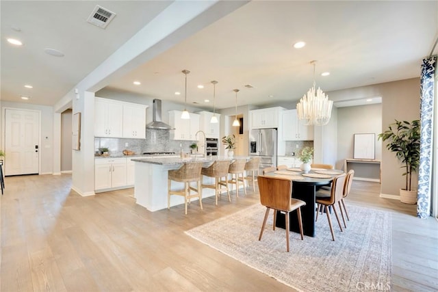 dining space with light hardwood / wood-style flooring