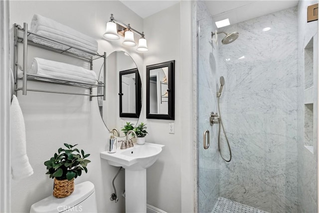 bathroom featuring toilet and a stall shower