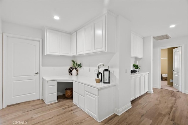 interior space with light wood-style flooring, visible vents, and recessed lighting