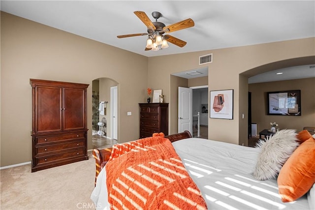 bedroom with light carpet, visible vents, arched walkways, lofted ceiling, and ceiling fan