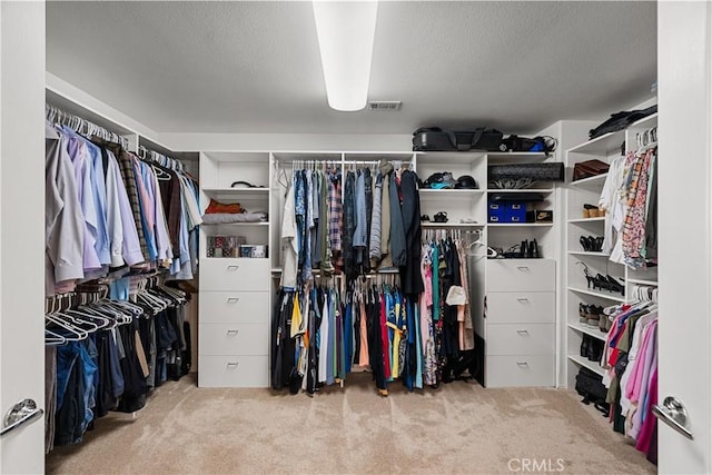 spacious closet with carpet flooring and visible vents