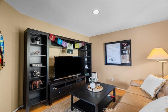 living area featuring recessed lighting, baseboards, and wood finished floors