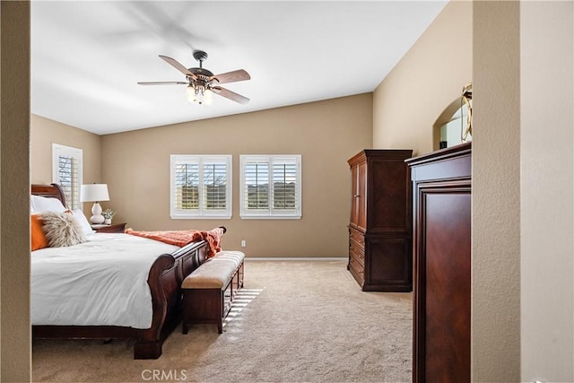 bedroom featuring lofted ceiling, light colored carpet, and ceiling fan