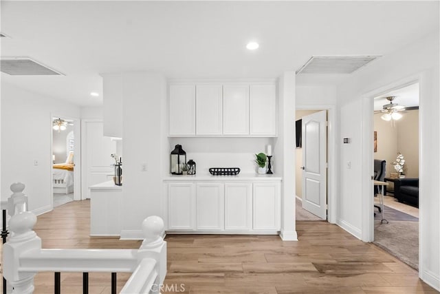 interior space with a ceiling fan, recessed lighting, visible vents, and light wood finished floors