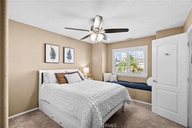 bedroom featuring baseboards, visible vents, ceiling fan, and light colored carpet