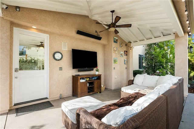 living room featuring a ceiling fan and vaulted ceiling with beams