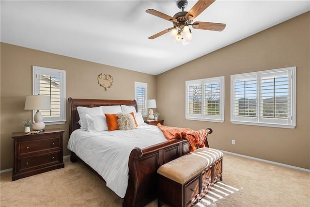 bedroom featuring vaulted ceiling, baseboards, a ceiling fan, and light colored carpet