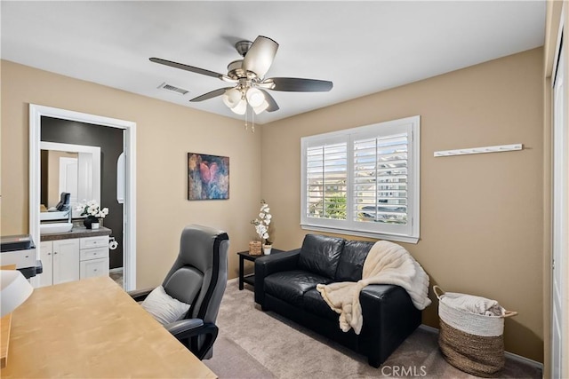 office area featuring carpet, visible vents, ceiling fan, and baseboards