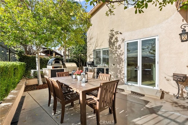 view of patio / terrace with fence, outdoor dining area, and area for grilling