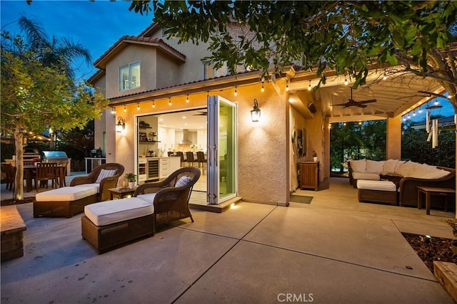 back of house with a patio area, stucco siding, and an outdoor hangout area