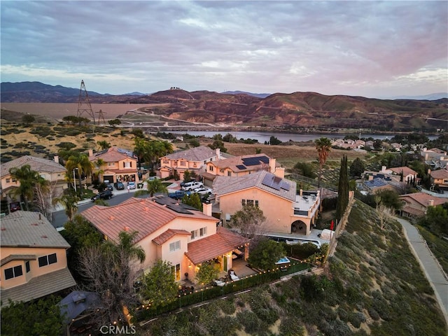 bird's eye view with a water and mountain view and a residential view