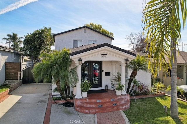 view of front of house featuring a gate and stucco siding