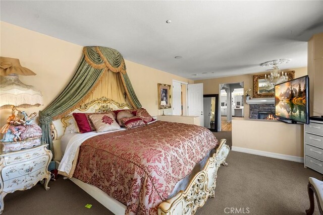 2503 N San Miguel Dr, Orange, CA 92867 - bedroom featuring carpet flooring, a stone fireplace, and baseboards