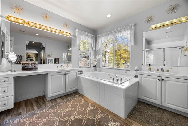 2503 N San Miguel Dr, Orange, CA 92867 - full bathroom with two vanities, wood finished floors, a bath, a shower stall, and recessed lighting