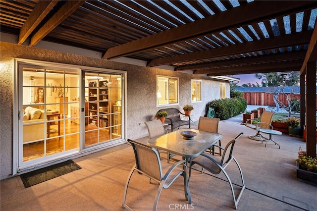 patio terrace at dusk featuring a pergola