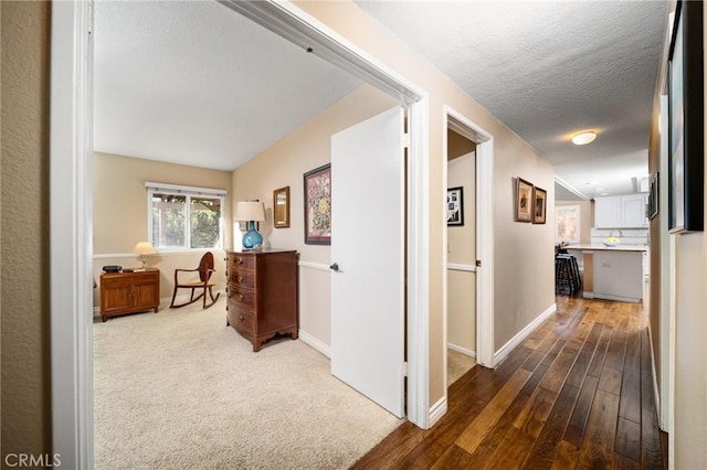 hall featuring hardwood / wood-style flooring and a textured ceiling