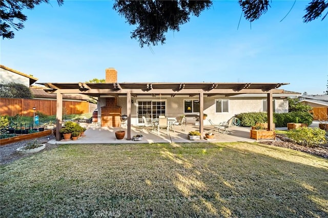 rear view of house with a lawn and a patio area