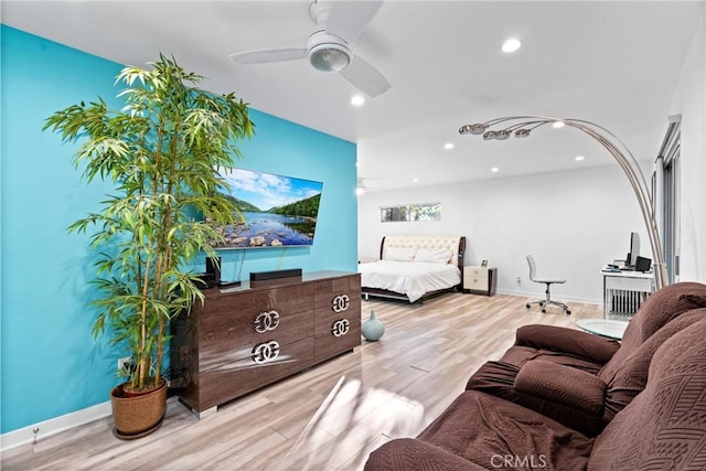 interior space featuring baseboards, ceiling fan, recessed lighting, and light wood-style floors