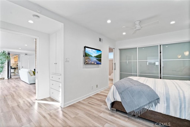 bedroom with recessed lighting, light wood-style flooring, and baseboards