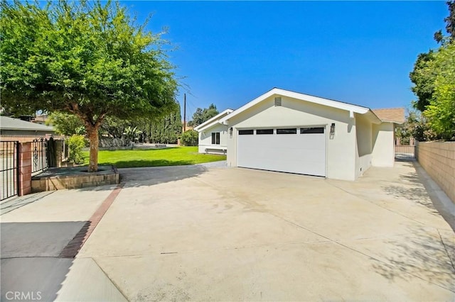 view of side of property with a yard and a garage