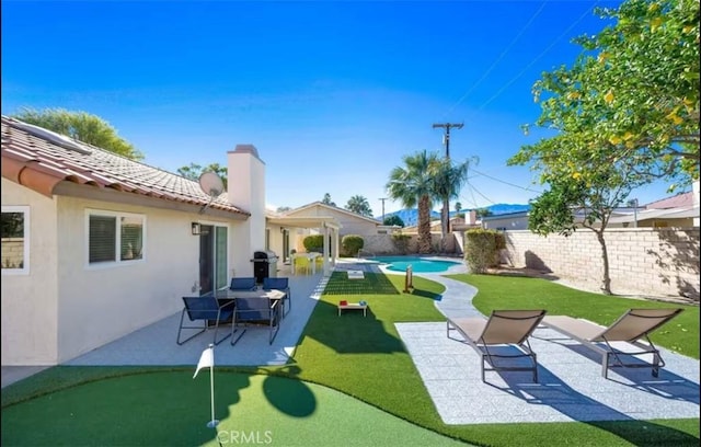 view of yard featuring a patio area and a fenced in pool