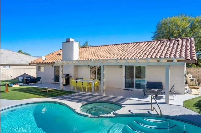 rear view of house featuring a pool with hot tub, a patio, and a pergola