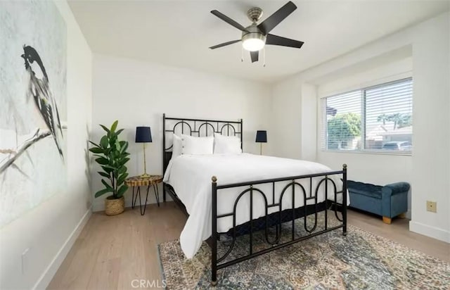 bedroom with hardwood / wood-style flooring and ceiling fan