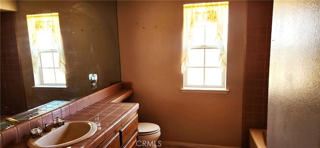 bathroom with toilet,  shower combination, and vanity