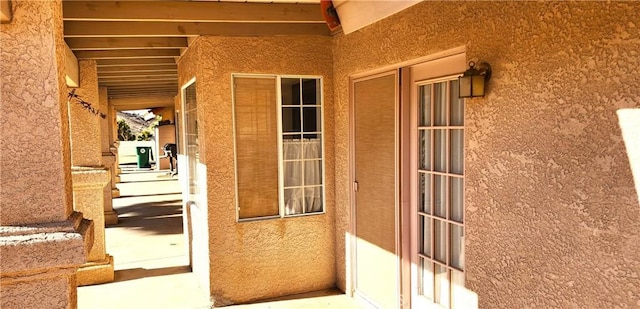 doorway to property with stucco siding