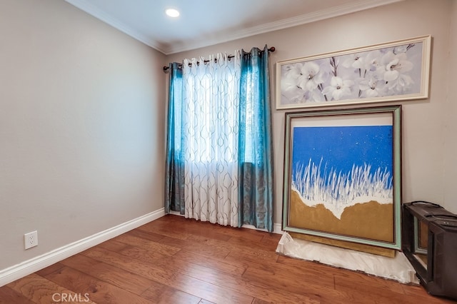 interior space featuring hardwood / wood-style flooring and crown molding