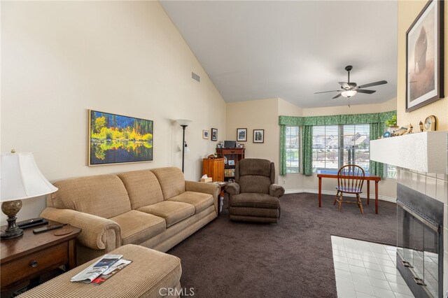 carpeted living area featuring visible vents, baseboards, ceiling fan, a fireplace, and high vaulted ceiling