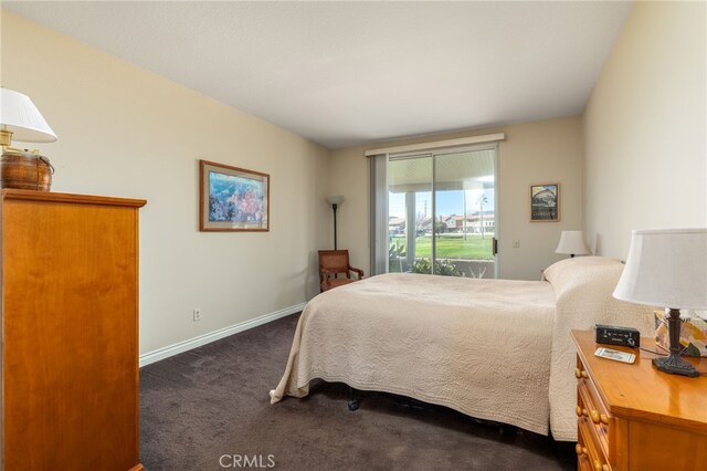 bedroom featuring access to exterior, baseboards, and dark colored carpet