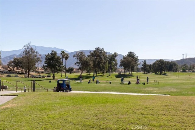 view of community with a lawn and a mountain view