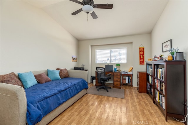 bedroom featuring lofted ceiling, light wood-style flooring, and ceiling fan