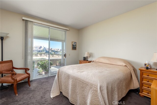 bedroom with access to exterior and dark colored carpet